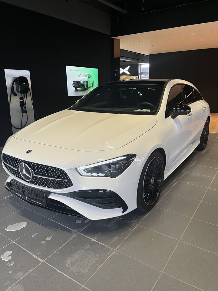 Weißes Mercedes-Benz Coupé im dunklen Ausstellungsraum